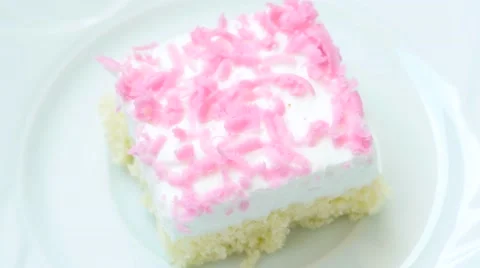 Cake with pink decoration rotates on white plate Stock Footage 54228963