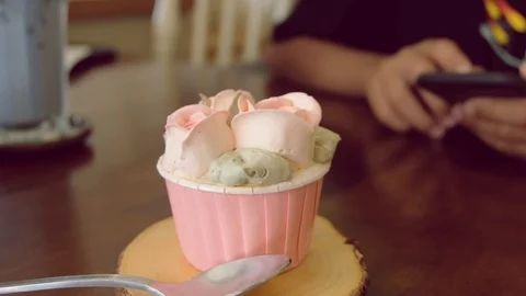 The cake that is placed on the table and child hand playing the smartphone Stock Footage 111319039