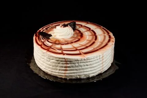 Cake on a plate on a black background Stock Photos