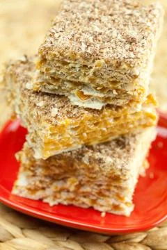 Cake on a plate on a wicker mat Stock Photos