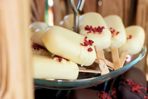 Cake pops in white chocolate in the shape of a mini ice cream on a stick. Cak Stock Photos