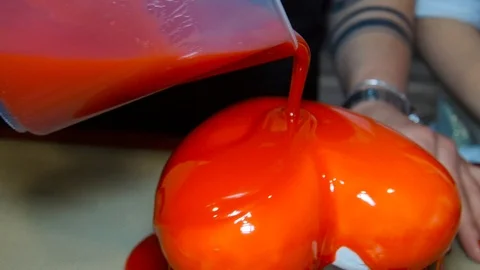 The cake is poured into a red glaze Stock Footage 91549086