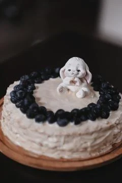 A cake with a rabbit on it and blueberries on the top. Stock Photos