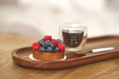 Cake with raspberry and cup of coffee. Stock Photos