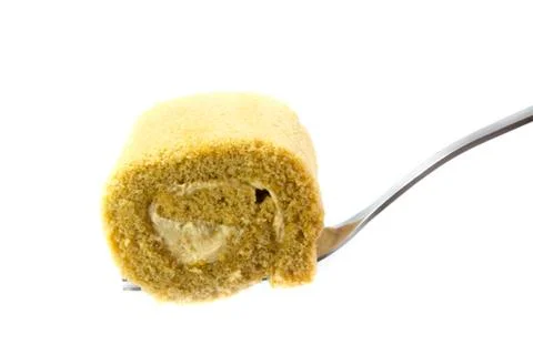 Cake roll on white background with a spoon 写真素材