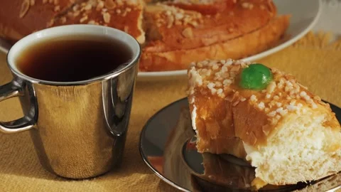 Cake Roscon de reyes with cup of black tea on the table. A traditional pastry Stock Footage 335140722
