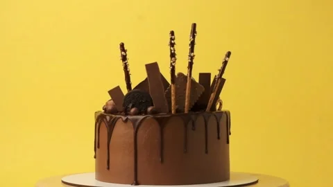 Cake rotating on yellow background Stock Footage 237332144