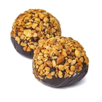 Cake rum truffle two balls with chopped nuts isolated on the white background Stock Photos