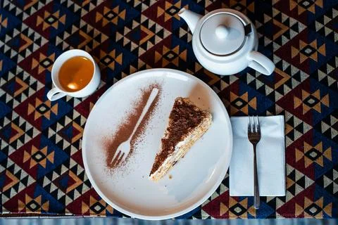 Cake Slice with Tea on Patterned Tablecloth Stock Photos