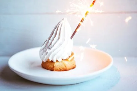 Cake with sparkler on blue background Stock Photos