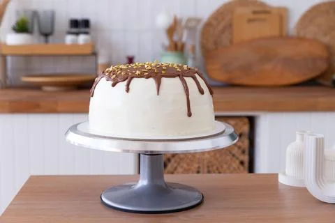 Cake on a stand stands on the table. Stock Photos