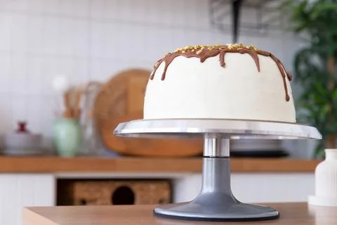 Cake on a stand stands on the table. Stock Photos