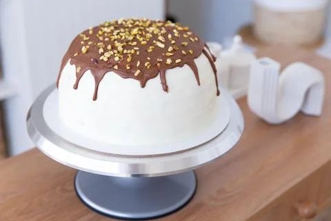 Cake on a stand stands on the table. Stock Photos