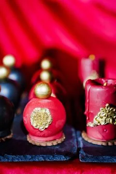 Cake, sweets in the shape of perfume bottles and candles Stock Photos