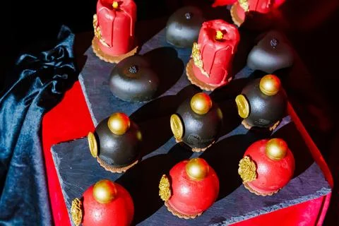 Cake, sweets in the shape of perfume bottles and candles Stock Photos