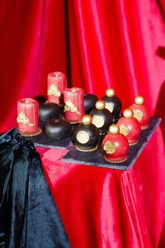Cake, sweets in the shape of perfume bottles and candles Stock Photos