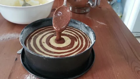 A cake with a swirl pattern is sitting on a wooden table Stock Footage 274489680
