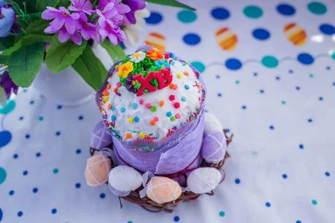 Cake on the table for Easter. Purple and white eggs around the cake. Easter Stock Photos