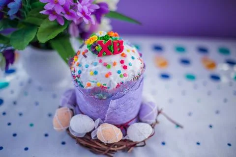 Cake on the table for Easter. Purple and white eggs around the cake. Easter Stock Photos