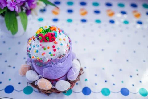 Cake on the table for Easter. Purple and white eggs around the cake. Easter Stock Photos
