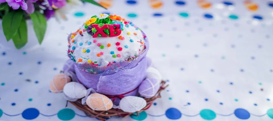 Cake on the table for Easter. Purple and white eggs around the cake. Easter Stock Photos