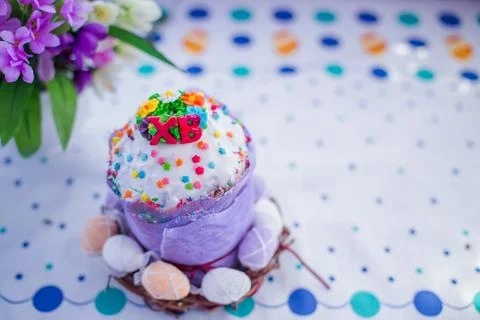 Cake on the table for Easter. Purple and white eggs around the cake. Easter Stock Photos