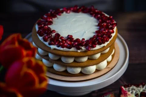 A cake of three layers consisting of cakes and white cream, decorated with Stock Photos