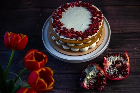 A cake of three layers consisting of cakes and white cream, decorated with Stock Photos
