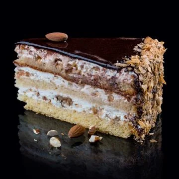 Cake with three types of caramel nuts on a black background Stock Photos