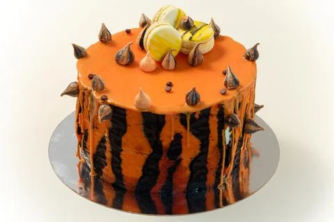 Cake with tiger stripes pattern and macaroons for man or boy. Sweet pastry Stock Photos