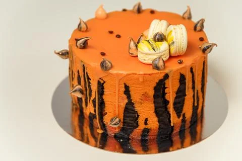 Cake with tiger stripes pattern and macaroons for man or boy. Sweet pastry Stock Photos