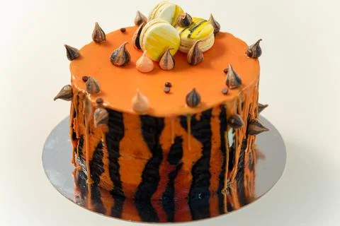 Cake with tiger stripes pattern and macaroons for man or boy. Sweet pastry Stock Photos