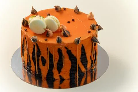 Cake with tiger stripes pattern and macaroons for man or boy. Sweets Stock Photos
