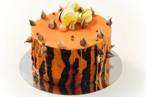 Cake with tiger stripes pattern and macaroons for man or boy. Sweet pastry Stock Photos