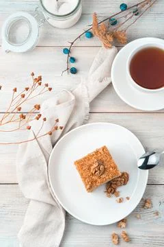 Cake with walnuts on a soft light background. The view from the top. Stock Photos