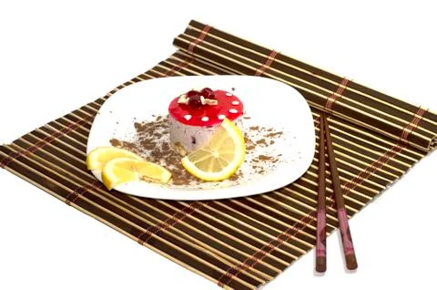 Cake white, with lemon segments, with grated chocolate, on a rug, the top vie Stock Photos