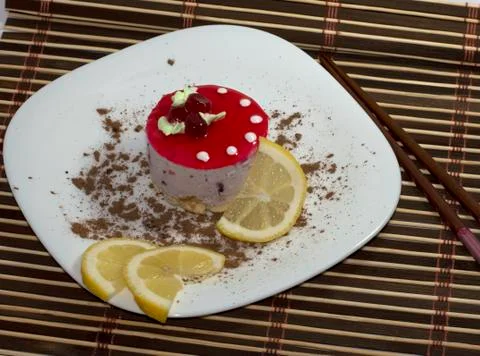 Cake white, with lemon segments, with grated chocolate, the top view Stock Photos