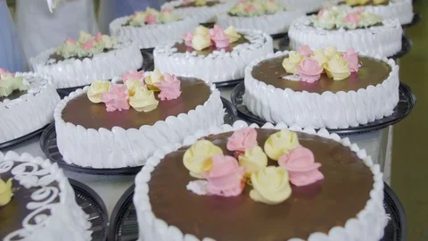 Cakes decorating. Workers decorating cakes at a cake factory. Confectionery Stock Footage 70657848