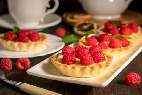 Cakes with raspberries on the table Stock Photos