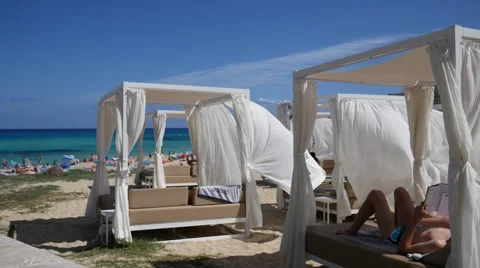Cala Mesquida Mallorca Majorca:  Guy reading on a sun umbrella at the beach Video stock 63162863