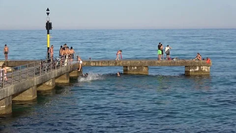Cala Millor Mallorca Spain: Children and teenagers playing on a pier in the sea Video stock 81069073