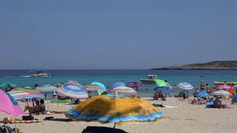 Cala Millor Mallorca Spain: People relaxing on the beach under colourfull sun Video stock 81068853