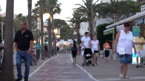 Cala Millor Mallorca Spain: Tourists walking on the promenade in the evening 库存影片 81069111