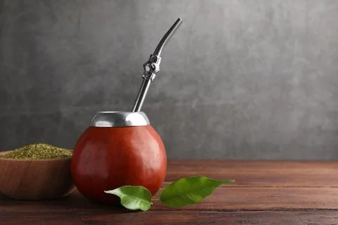 Calabash with mate tea and bombilla on wooden table. Space for text Stock Photos