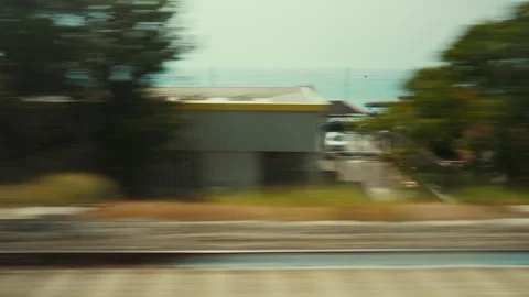Calabrian beach and seafront seen from a train window in summer Stockbeeldmateriaal 340275000