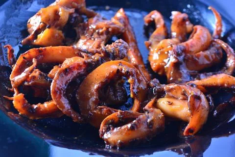 Calamari ring centered with curled squid tentacles macro 스톡 사진
