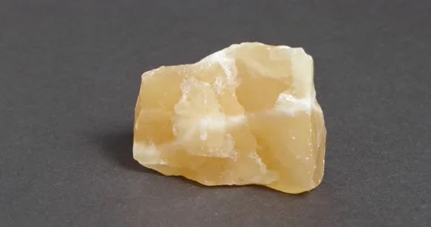 Calcite orange close-up on dark background. Rotation. Stock Footage 164285674