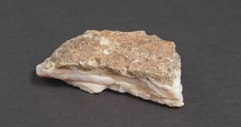 Calcite pink on a dark background. Untreated natural stone. Видео 163787207