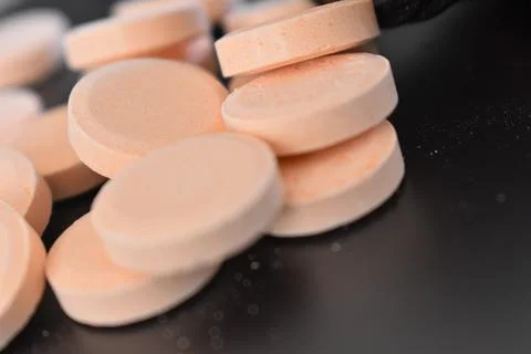 Calcium tablets on dark background Stock Photos