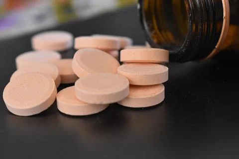 Calcium tablets on dark background Stock Photos